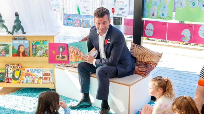 Associate Education Minister David Seymour reads to children at the Co Kids Thorndon Quay early childhood education centre. Photo / Mark Mitchell