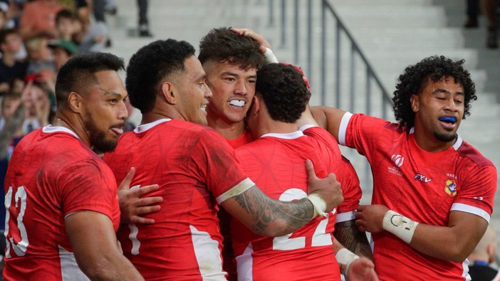 Tonga's Kyren Taumoefolau, middle, celebrates after scoring a try against Romania. Photo / AP