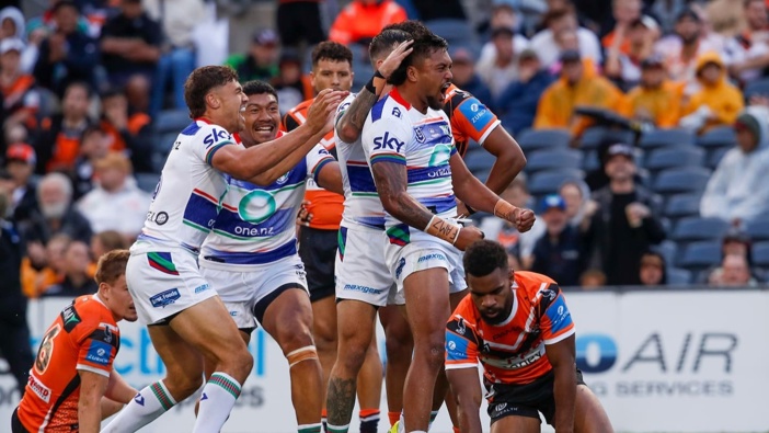 Adam Pompey celebrates with teammates after scoring against Wests Tigers. Photo / Photosport