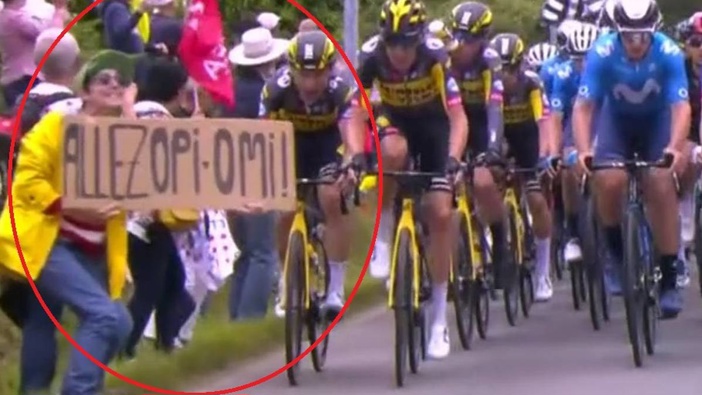 A spectator holds up a sign that caused a mass pileup at the Tour de France. (Photo / NZ Herald)