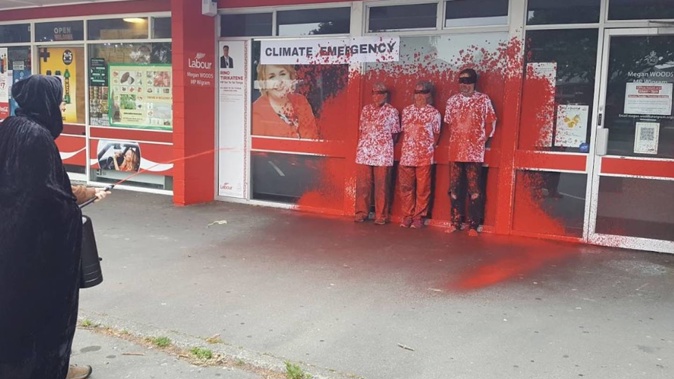 Restore Passenger Rail protesters are spray painted red outside Megan Woods' office. Photo / Supplied