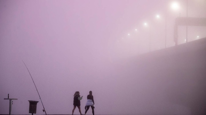 Fog hides Auckland Harbour Bridge on Wednesday. Photo / Michael Craig