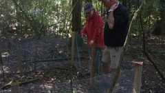 Landowners Phyll and Stu Gibson look on the growth within the rabbit exclosure.