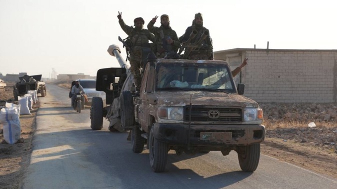 Rebels In Northwest Syria seized military vehicles belonging to the regime along the route toward Kweris Airpor. Photo / AFP