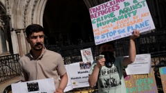 Protesters stand outside the High Court where the ruling on Rwanda deportation flights is taking place, in London Monday, June 13, 2022. (Photo / AP)