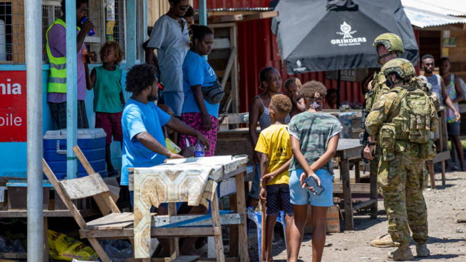 Australian Army soldiers talk with local citizens during a community engagement patrol through Honiara, Solomon Islands. (Photo / Australia Defence Force via AP)