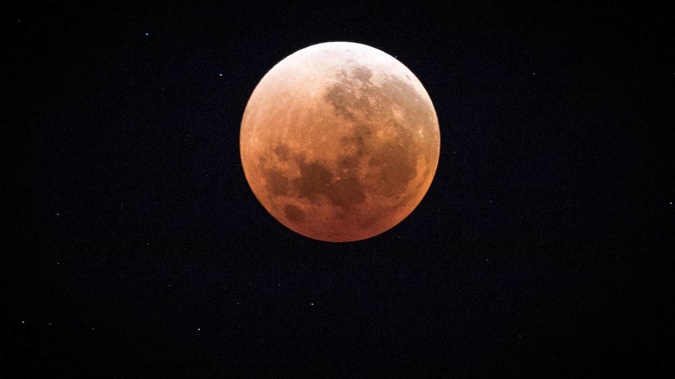 A "blood moon" seen from Auckland in February 2018. A "blood micro-moon" is due in our night skies this Friday. (Photo / Michael Craig)