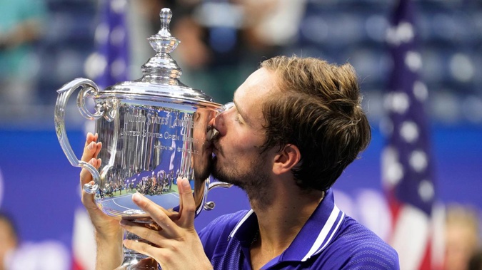 Daniil Medvedev, of Russia, kisses the championship trophy after defeating Novak Djokovic, of Serbia, in the men's singles final of the US Open. (Photo / AP)