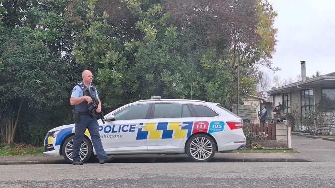 Police with guns at the cordon on Buckingham St, Whakatu. Photo / Michaela Gower 17 July 2025 NZME photographed by Michaela Gower.
