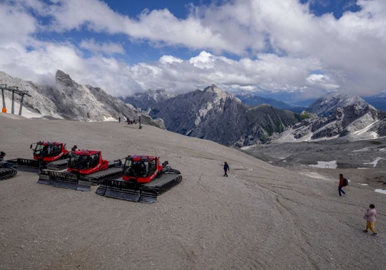 FILE - Snow cats are parked on top of Zugspitze mountain near Garmisch-Partenkirchen, June 25, 2022. Scientists in Germany stripped the Southern Schneeferner, a sheet of ice on a plateau south of the peak of its status as glacier after extreme heat this summer hastened its demise. (AP Photo/Michael Probst, File)