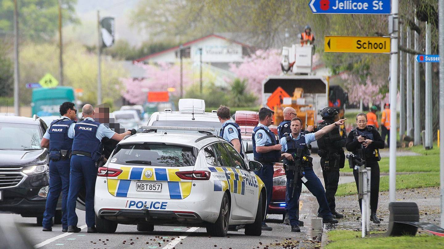 A man being taken into custody next to Windsor Park. Photo / Warren Buckland