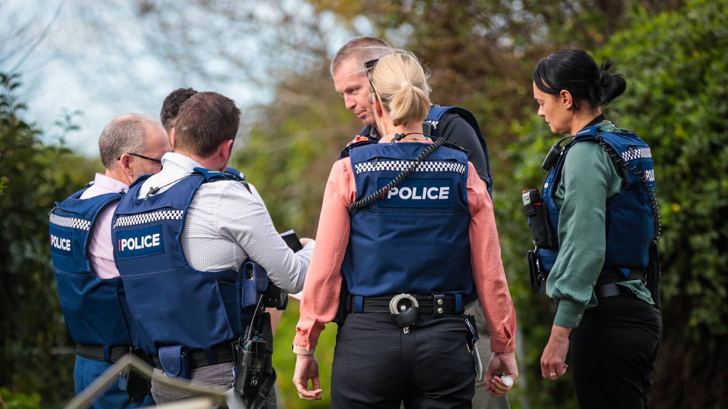 Police gathered outside a Bedford Rd address, where a woman was arrested shortly after a man was found on Kennedy Rd with injuries which appeared to be the result of being stabbed. Photo / NZME