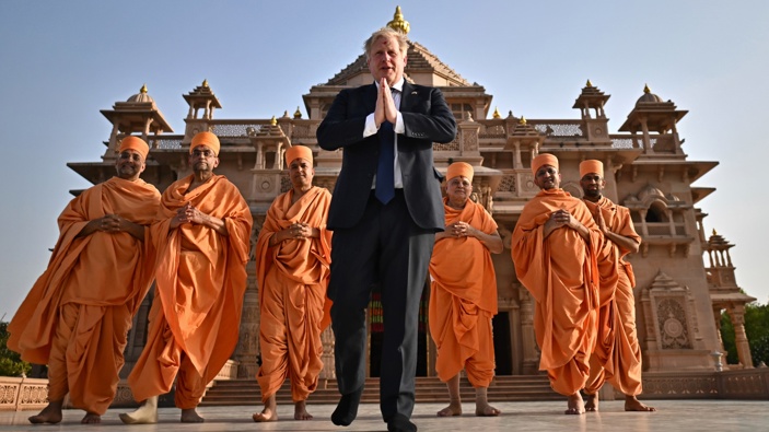 Britain's Prime Minister Boris Johnson, center, poses with Sadhus, or Hindu holy men, in front of the Swaminarayan Akshardham temple, in Gandhinagar, part of his two-day trip to India, Thursday, April 21, 2022. (Photo / AP)