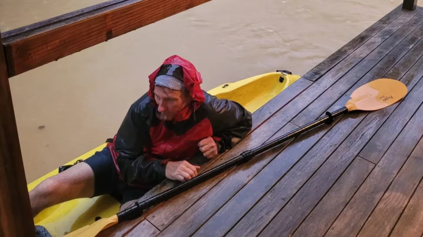 Brave dad saves daughter and partner from flooded home by kayak