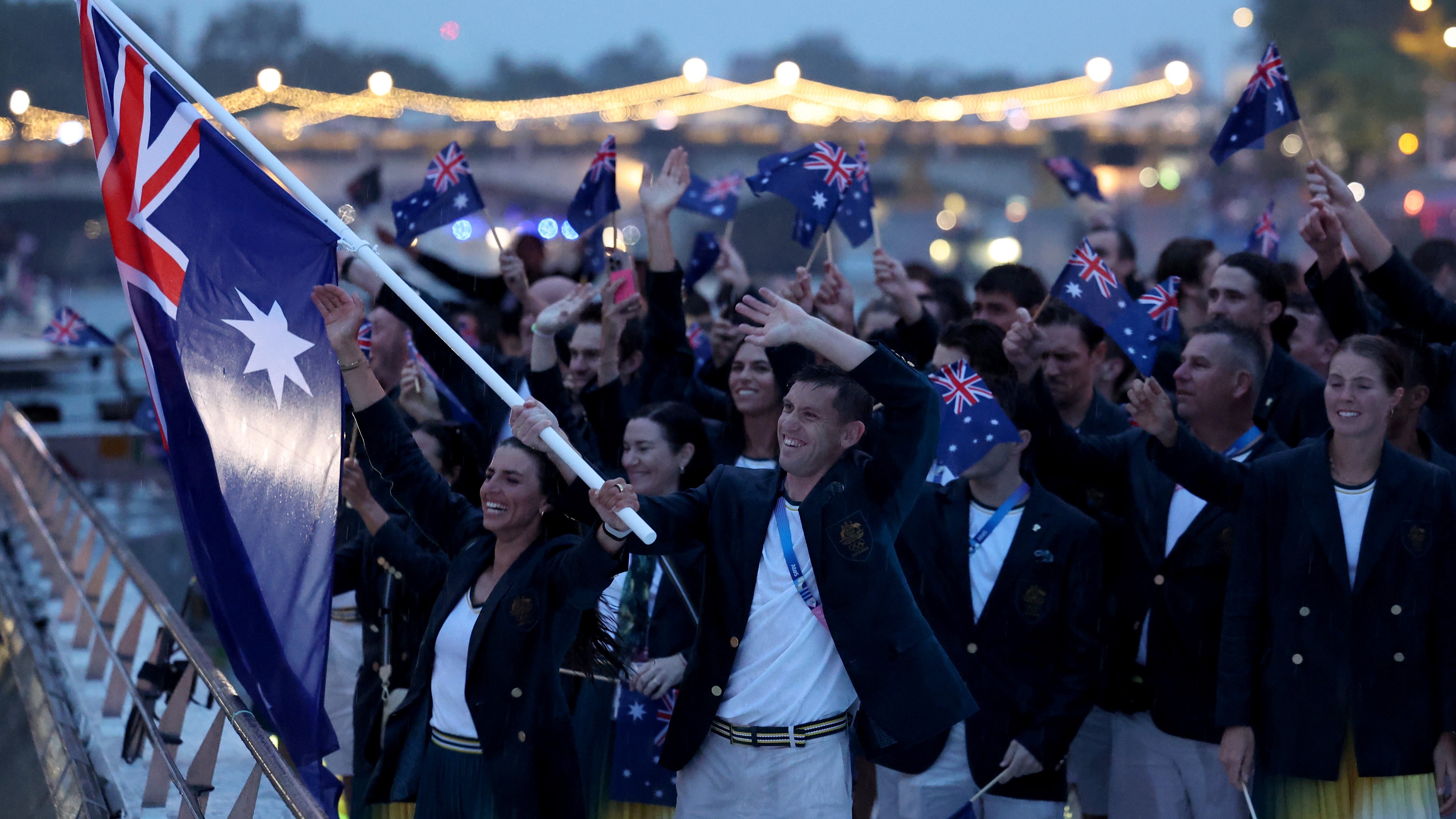 Team Australia are seen waving their hand held flags on a boat along the River Seine during the opening ceremony of the Olympic Games Paris 2024 on July 26, 2024 in Paris, France. (Photo by Quinn Rooney/Getty Images)