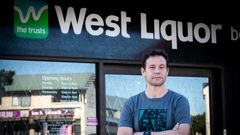 Pushing for competition: Waltag spokesperson Nick Smale in fron of one of The Trusts' "West Liquor" bottle stores in Te Atatū. Photo / Jason Oxenham
