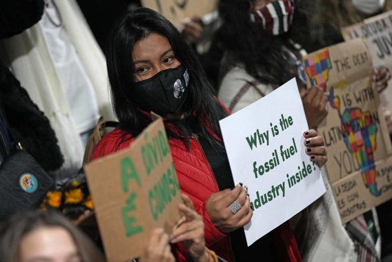 Youth climate activists protest that representatives of the fossil fuel industry have been allowed inside the venue during the COP26 U.N. Climate Summit in Glasgow, Scotland. (Photo / AP)
