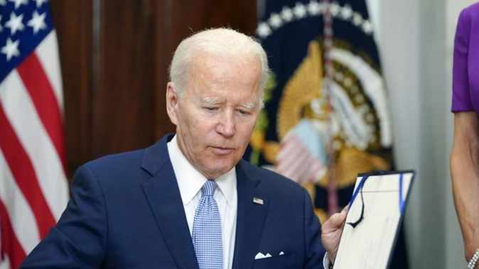 US President Joe Biden signs into law S. 2938, the Bipartisan Safer Communities Act gun safety bill, in the Roosevelt Room of the White House in Washington. Photo / AP