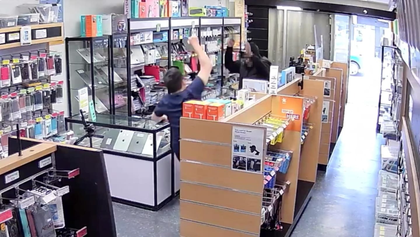 A screenshot from a CCTV camera shows the owner of FoneMate in Hastings falling to the ground after being pushed. Photo / Supplied