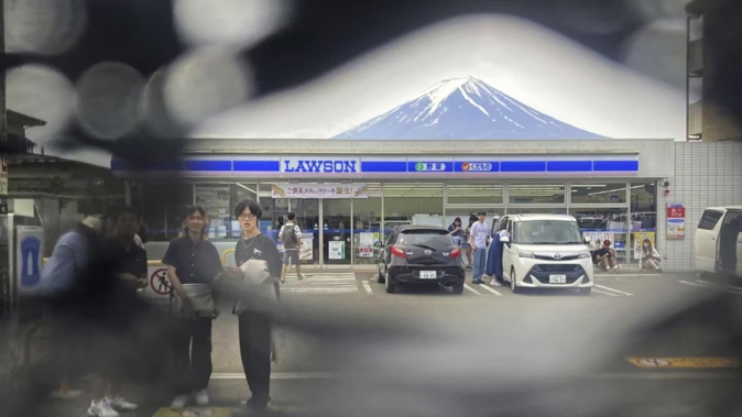Officials in Japan are working to fix holes in a screen designed to discourage snap-happy visitors. Photo / AP