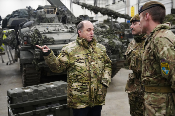 Britain's Defence Secretary Ben Wallace, left, speaks with Britain's military officers during his visit to the Tapa Military Camp, in Estonia, Thursday, Jan. 19, 2023. Wallace said his country would send at least three batteries of AS-90 artillery, armoured vehicles, thousands of rounds of ammunition and 600 Brimstone missiles, as well as the squadron of Challenger 2 tanks. Photo / AP