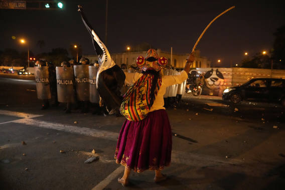 An anti-government protester confronts a phalanx of riot police after clashes erupted during a march against President Dina Boluarte, in Lima, Peru, Monday, Jan. 23, 2023. Protesters are seeking immediate elections, Boluarte's resignation, the release of ousted President Pedro Castillo and justice for the protesters killed in clashes with police. Photo / AP