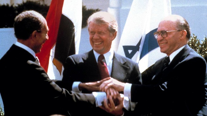 Egyptian President Anwar Sadat (left), US President Jimmy Carter (centre) and Israeli Prime Minister Menachem Begin clasp hands on the north lawn of the White House as they complete the signing of the peace treaty between Egypt and Israel in Washington DC on March, 26, 1979. Photo / AP