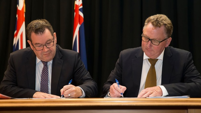 Grant Robertson and Adrian Orr signing the new Policy Targets Agreement in March 2018. Photo / Mark Mitchell