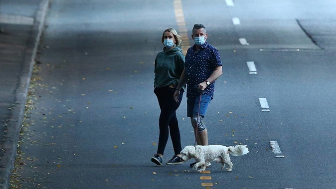 Residents in Brisbane walk near the empty CBD after a snap lockdown was put into effect. Photo / Getty Images