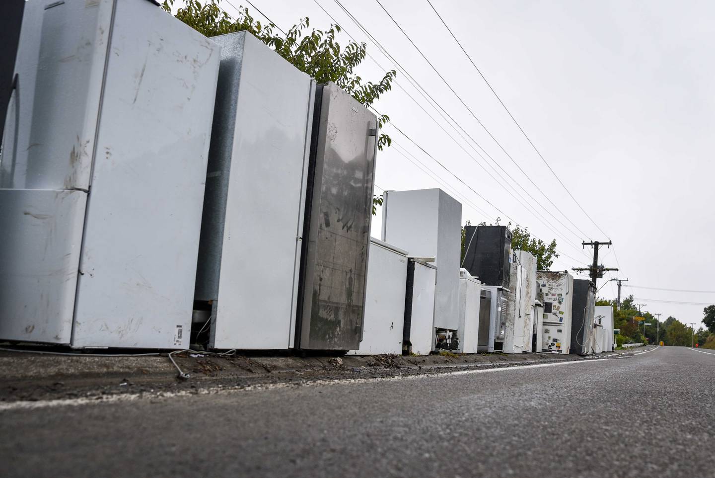 Ruined appliances waiting to be collected line part of the main street through Puketapu. Photo / Ian Cooper