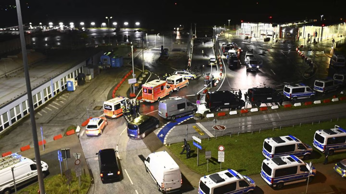 Police vehicles and ambulances arrive at the scene of a security breach at the Hamburg Airport. Photo / AP