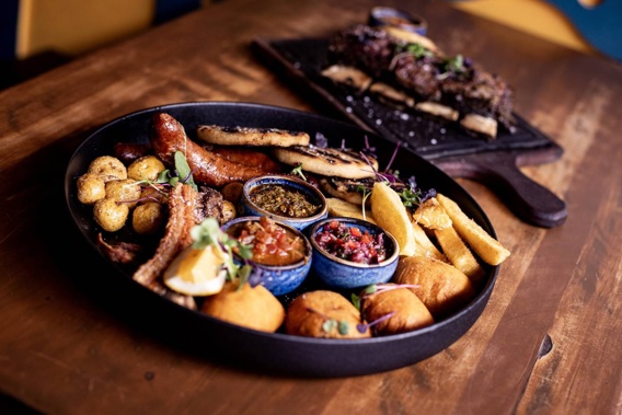 El Humero Colombian Eatery's fritanga platter and short ribs with cassava wedges and salsa criolla. Photo / Dean Purcell