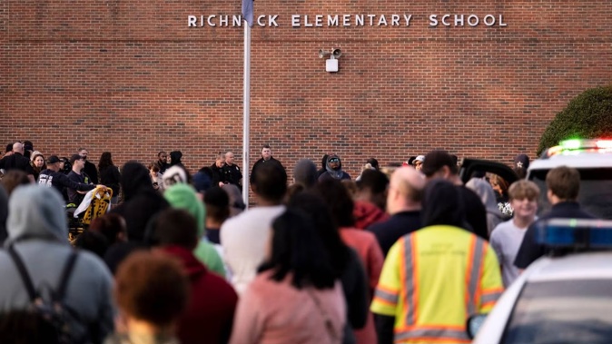 Students and police gather outside of Richneck Elementary School after the shooting on January 6. Photo / AP