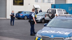 Police, including members of the Armed Offenders Squad, raided the Head Hunters' North Shore pad overnight. Photo / Michael Craig
