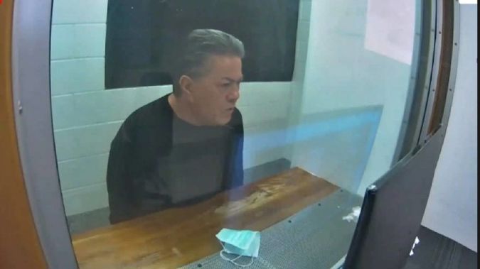 Destiny Church leader Brian Tamaki sits in a holding cell while attending his latest hearing via audio-video feed. (Photo / NZME)