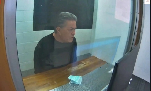 Destiny Church leader Brian Tamaki sits in a holding cell while attending his latest hearing via audio-video feed. (Photo / NZME)