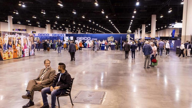 Two men take a break on a bench during the Berkshire Hathaway 2022 Annual Shareholders Meeting weekend at the CHI Health Centre in Omaha, Photo / AP