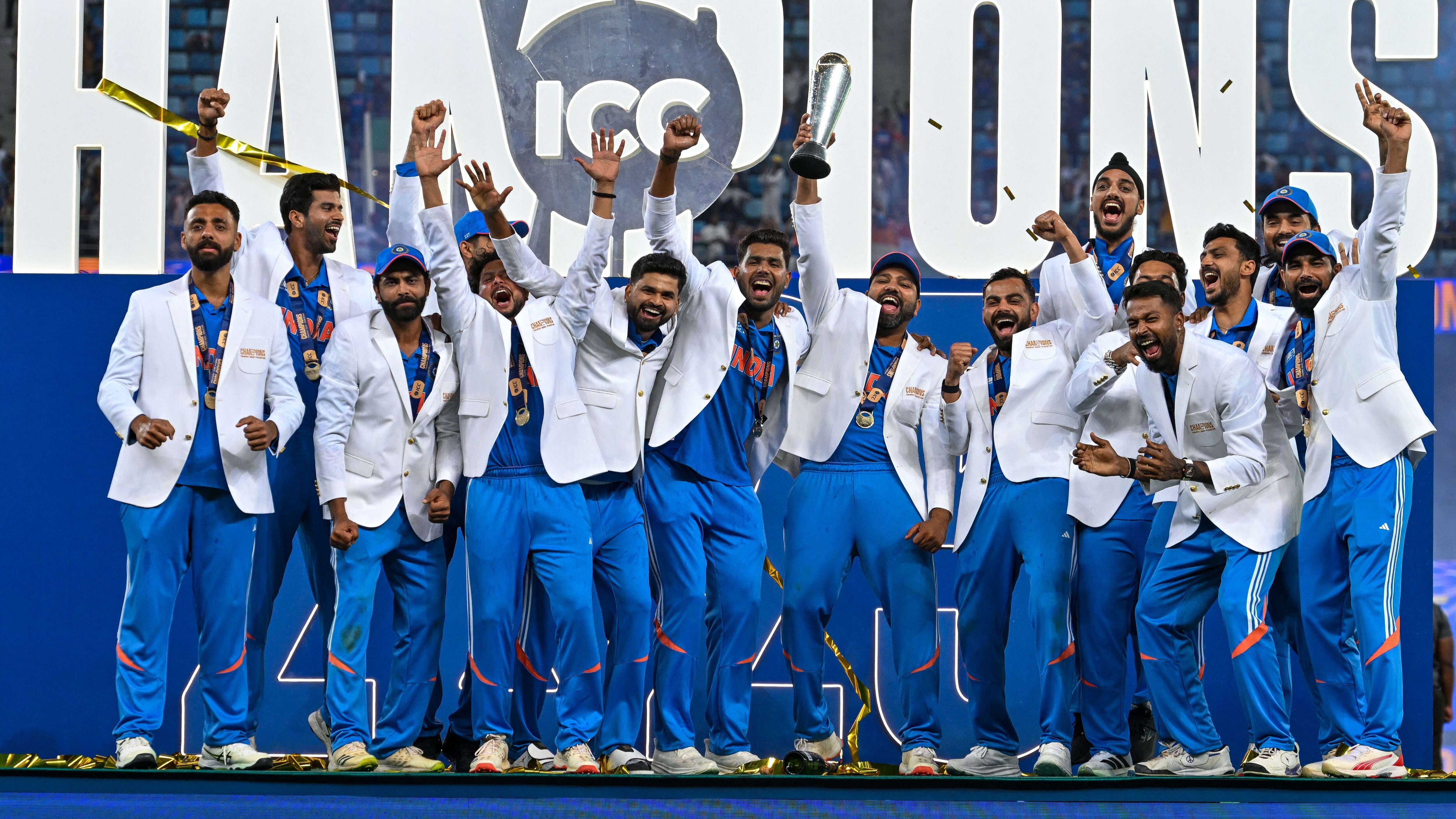 India's players celebrate with the trophy after winning the ICC Champions Trophy final, defeating New Zealand in Dubai. Photo / AFP