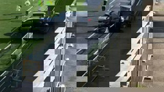 A car plunged metres on to a soccer field following a crash in Long Bay, Auckland this morning. Photo / Supplied