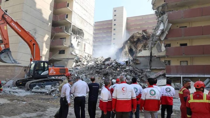 Iranian Red Crescent volunteers gathered in front of a building destroyed in an Israeli strike in Tehran. Photo / Iranian Red Crescent, AFP