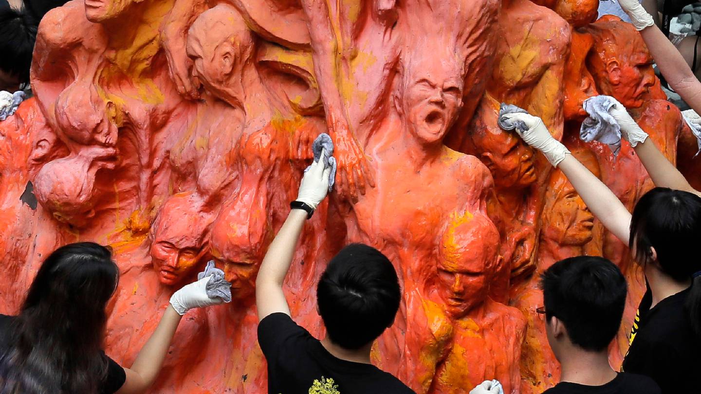 University students clean the Pillar of Shame statue, a memorial for those killed in the 1989 Tiananmen crackdown, which has now been removed. Photo / AP