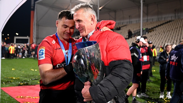 Rob Penney, pictured with the trophy and captain David Havili, has had a 180 degree career reversal. Photo / Getty