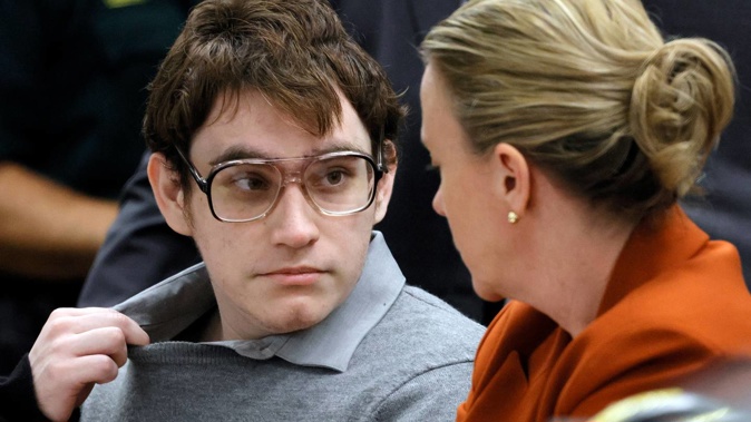 Marjory Stoneman Douglas High School shooter Nikolas Cruz tugs at his shirt collar as he is seated at the defence table with assistant public defender Melisa McNeill for the verdict in his trial at the Broward County Courthouse in Fort Lauderdale. Photo / AP