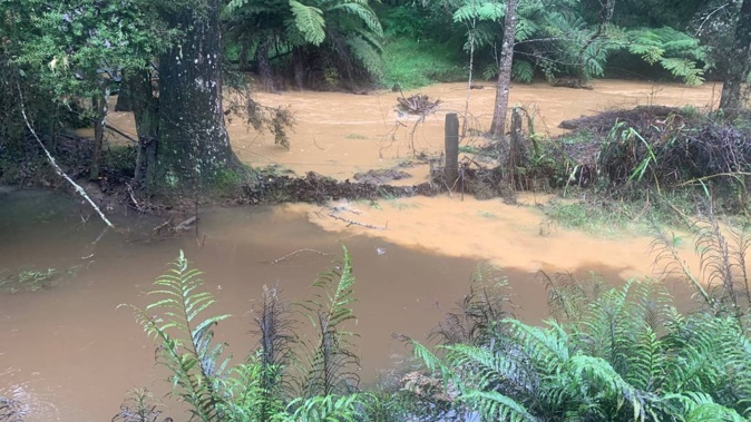 Sediment-laden water gushes through Shayne Tobin's property near Kaikohe in Northland. Photo / Supplied via RNZ
