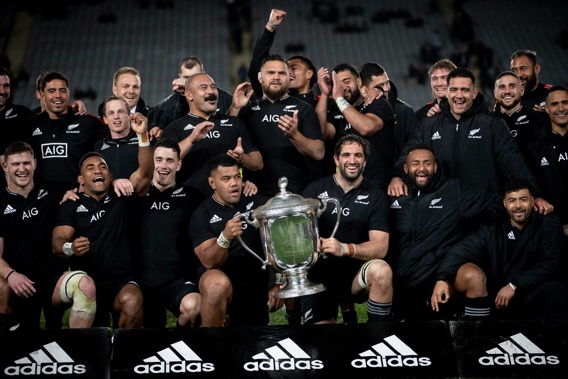 The All Blacks celebrate with the Bledisloe Cup after beating the Wallabies at Eden Park. (Photo/Dean Purcell)