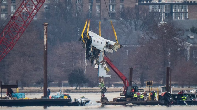 A crane removes wreckage from the Potomac River, where a jet and a military helicopter collided on January 30 (NZT). Photo / Jabin Botsford, The Washington Post