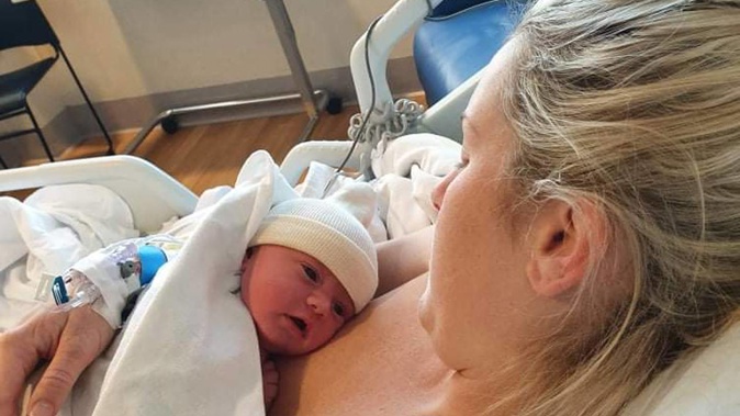 Courtney Seddon with baby Thea Elizabeth after being forced to give birth without her partner by her side due to testing positive for Covid-19. Photo / Supplied