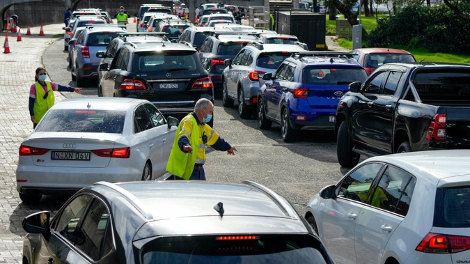 Traffic marshalls direct cars at a drive-through Covid-19 testing clinic at Bondi Beach in Sydney on January 8. Photo / AP