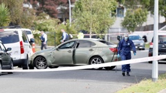 A vehicle of interest remains at the scene on Addington Ave, Manurewa, where one person died and another was critically injured. Photo / Dean Purcell