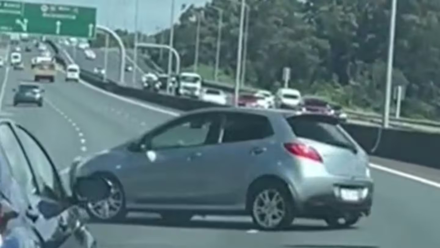 In the shocking footage, a Mazda Demio can be seen spinning out across multiple lanes on State Highway 16. Photo / Supplied